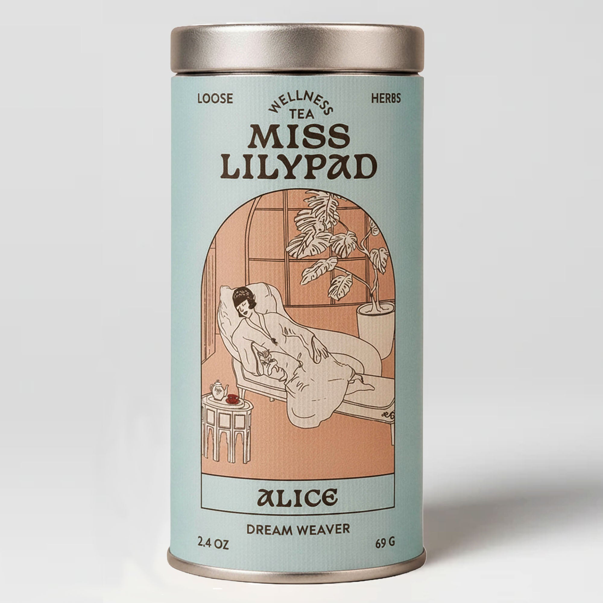 Miss Lilypad Dream Weaver Alice loose herbal tea in a cylindrical tin canister with a blue label and silver metal lid and base. An illustration of a closed eyed woman in a chaise lounge holding a cat next to a table with tea pot and red cup