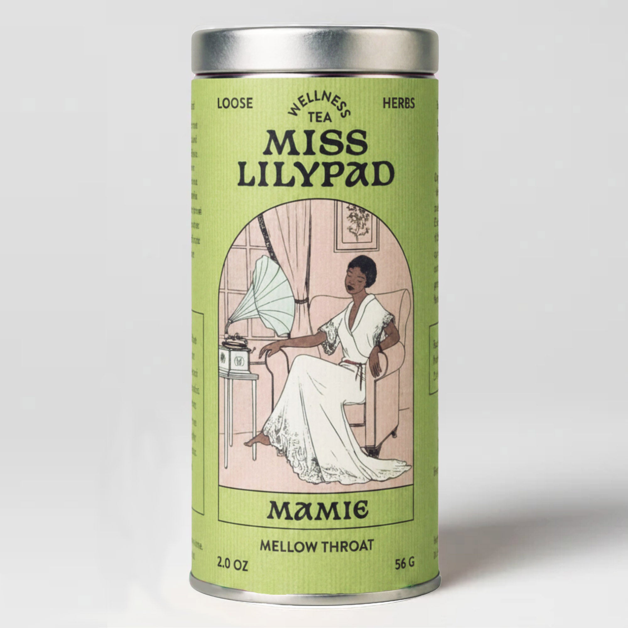 Miss Lilypad Mellow throat Mamie loose herbal tea in a cylindrical tin canister with a green label and silver metal lid and base. An illustration of a woman sitting in an armchair listening to music on a gramophone by the window