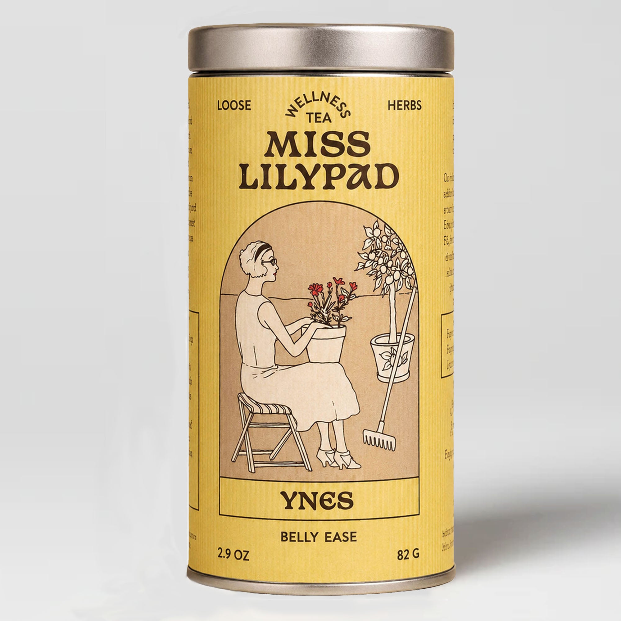 Miss Lilypad Belly Ease Ynes loose herbal tea in a cylindrical tin canister with a n yellow label and silver metal lid and base. An illustration of a woman sitting on a garden stool holding a red flower vase